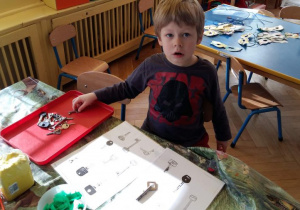 Chłopiec dopasowuje klucze z kącika Montessori.