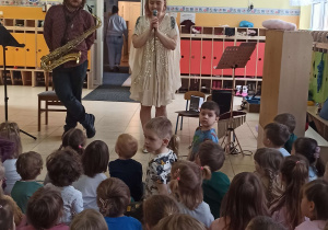 Muzycy prezentują dzieciom instrument muzyczny: saksofon